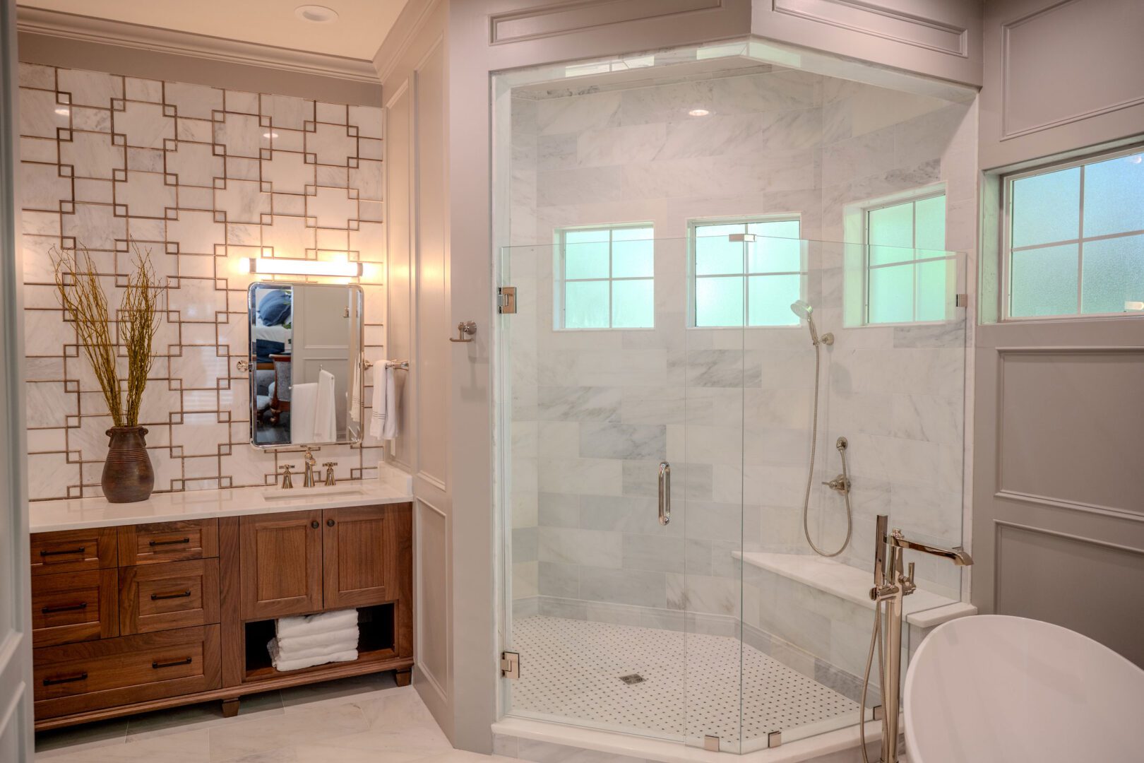 Modern bathroom with glass shower and elegant fixtures.